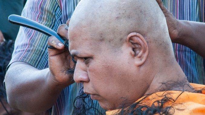 man getting head shaved at Thaipusam