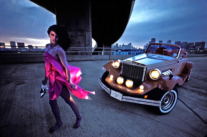 Photo of woman and sports car on stormy San Francisco evening by Gert Wagner