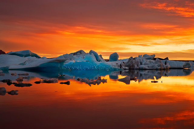 Sunset landscape image of iceberg during autumn in Iceland by Lewis Kemper.