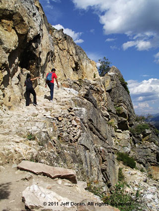 Image of hikers on a rock ledge at Inspiration Point, Grand Tetons, Wyoming by Jeff Doran.