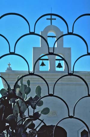 Image of San Xavier del Bac Mission taken through an ornate gate by Mike Goldstein.