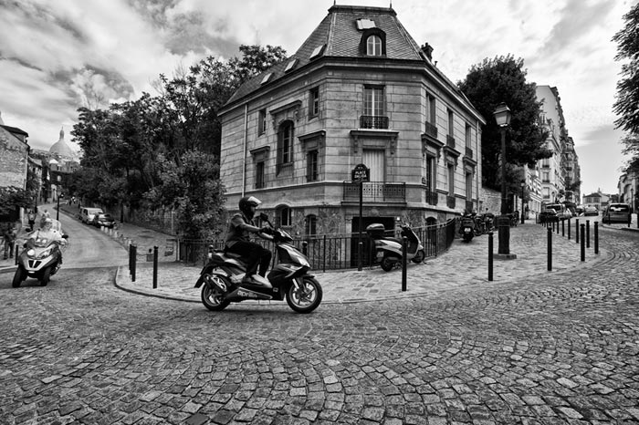 Photo of scooters in cobblestone street in Paris, France by Randy Romano