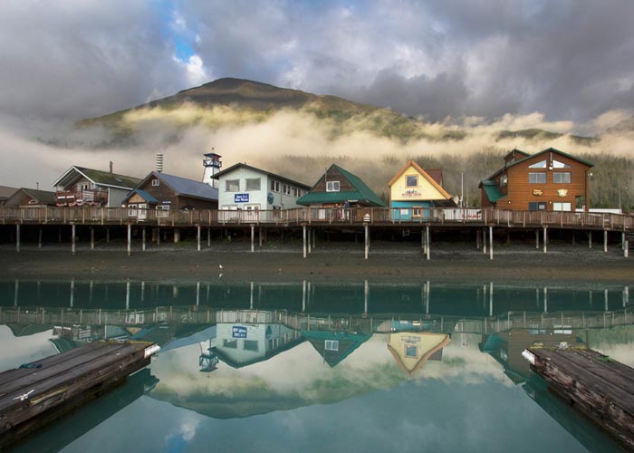 Reflection photo of buildings on Seward, Alaska pier by Barry Epstein