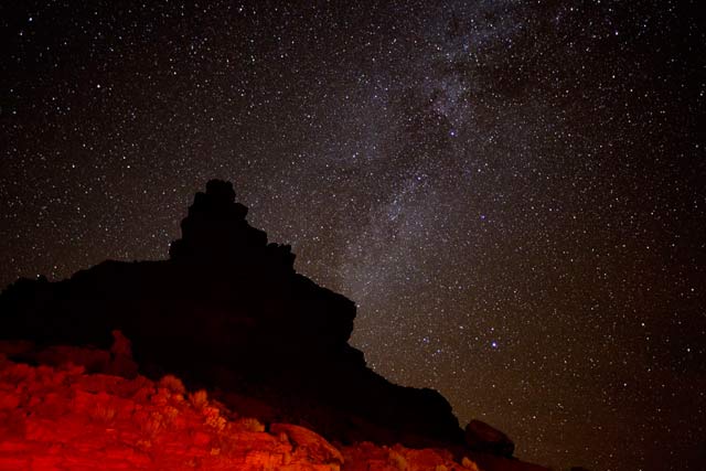 Star photography: flashlight on foreground rock formations and stars at Valley of the Gods, Utah by Andy Long.