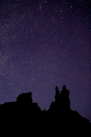 Star photography: image of stars at twilight with silhouetted rock formations at Valley of the Gods, Utah by Andy Long.