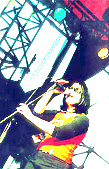 Over exposed color image of Cindy Ryan on stage by Lisa J. Young.