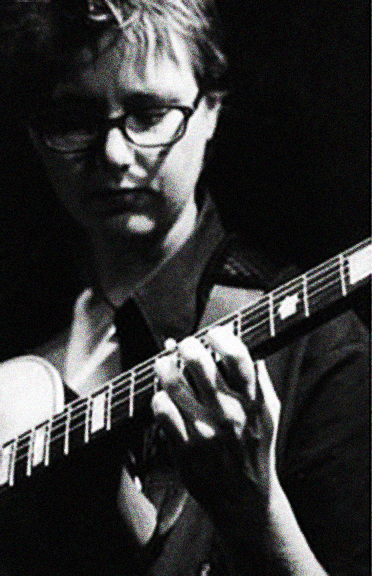 Black and white images of Sam Harley performing on his guitar by Lisa J. Young.