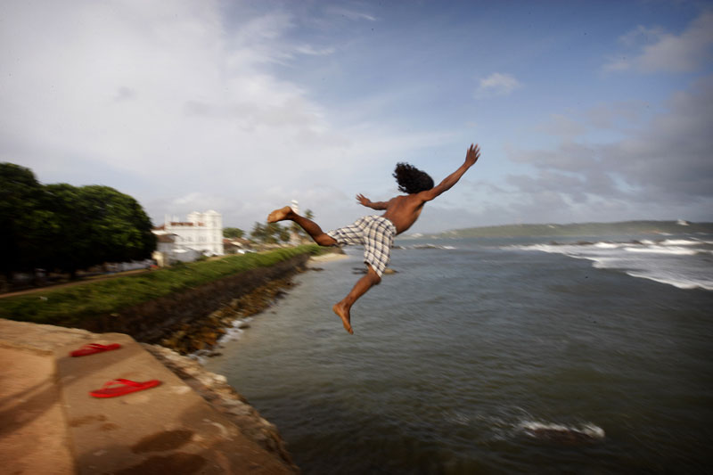 Photo of young man jumping into the sea-- Sri Lanka by Marielle van Uitert
