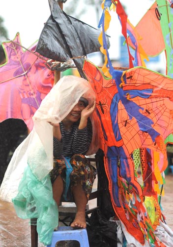 Photo of woman selling kites, Phnom Penh, Cambodia by Ron Veto