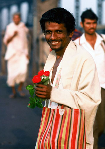 Photo of man with flowers in Calcutta, India by Ron Veto