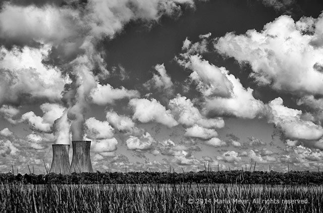 Black and white whimsical photo of cooling towers making clouds by Marla Meier.