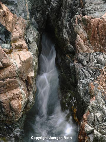 Photo of water streaming from rocks at Granite Coast near Thunder Hole by Juergen Roth.