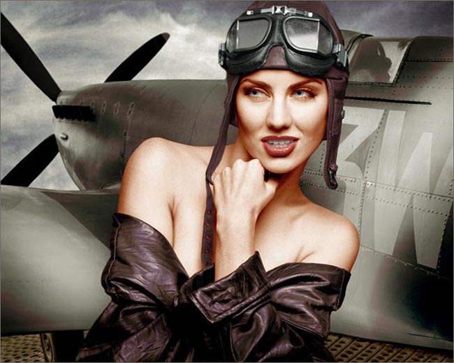 Photoshop colored photo of partially nude female model in retro style leather jacket and helmet in front of WWII plane from the retro series by Juul de Vries.