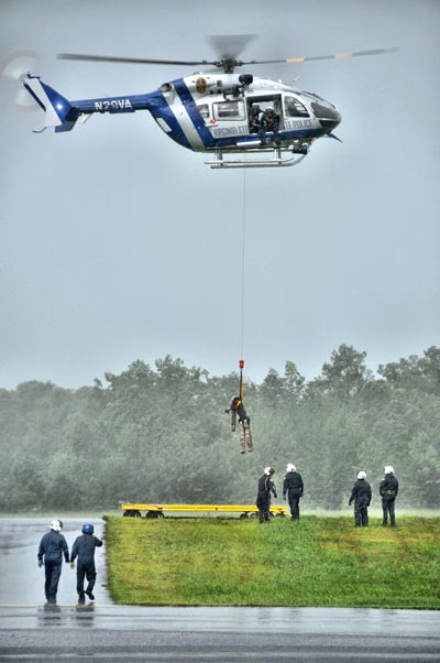 Aerial photography depicting vibration: photo of helicopter rescuing person by Allen Moore.