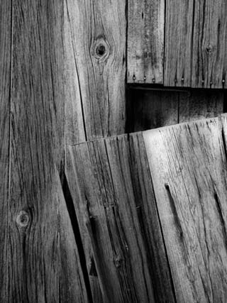 Backyard Photography: Black and white close-up photo of broken wood on the side of a barn by Randall Romano