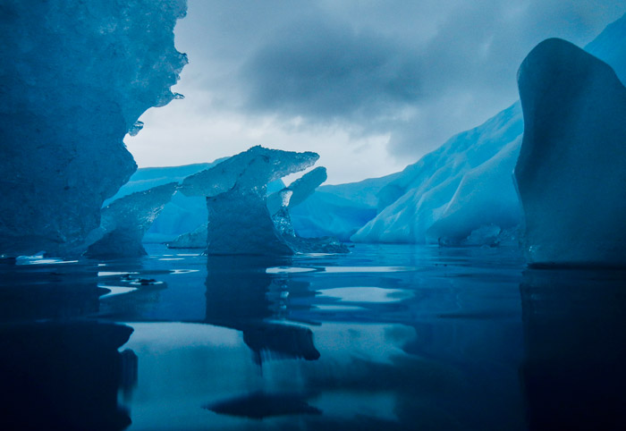 Photo of a blue-colored icebergs in Antarctica by Michael Leggero.