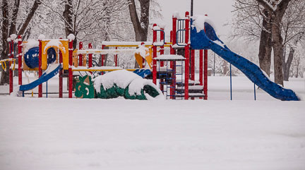 Photo of children's colorful playground equipment in the snow by Brad Sharp