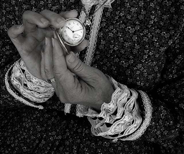 Image of hands holding an open pocket watch by Jim Austin.