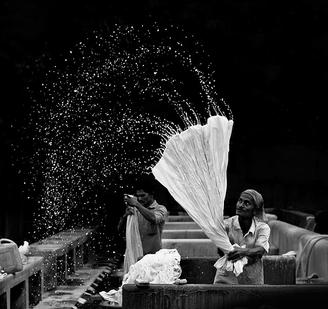 Black and white image of Mr. Spinner, a man in a Dhobighat in India, where people wash the clothes by G. Krupa Sindhu.