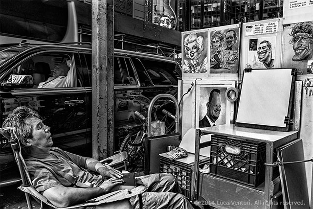 Black and white image of an artist sleeping near his work and a man sleeping in his car on the street in New York City by Luca Venturi.