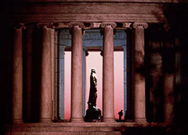 Image of a tourist looking up at the statue of Jefferson at the Jefferson Memorial in Washington D.C. by Steve Gottlieb.