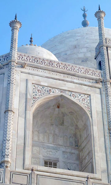 Photo of the in-laid flowers and Koranic scripture on Taj Mahal by Rick Clark