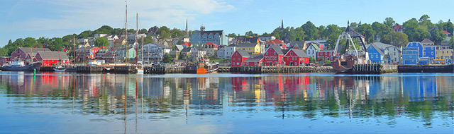 Reflection on water of the colorful building at the Lunenberg Harbor in Nova Scotia, Canada by Jim Autin.