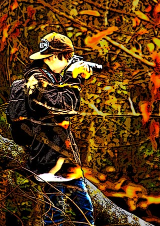 Image of young man making photos in the woods by Marla Meier.