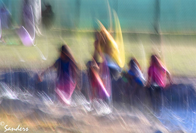 Photo Impressionism technique: image of people in a park using camera shake and oversaturated color to create an impressionistic effect by Gerald Sanders.