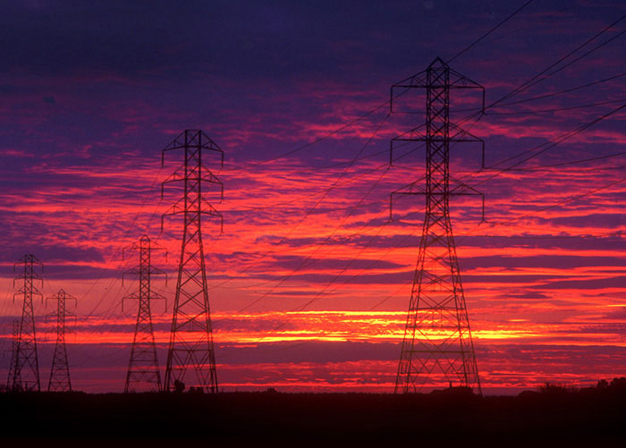 Sunset landscape photo of electrical towers in Central Valley, California by Noella Ballenger