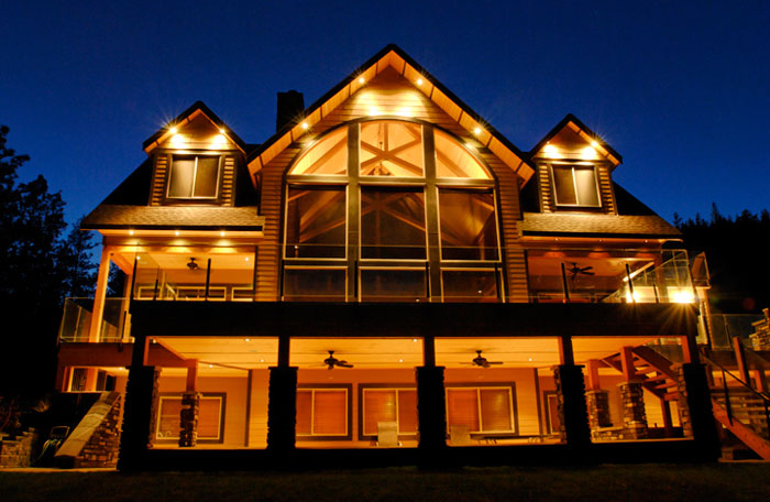 Exterior photo of home at dusk with house lights on by Randy Romano