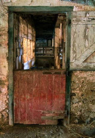 Photographing Historial Place: Kuerner Farm worn, partially open red barn door and looking through the barn by Gary Anthes.