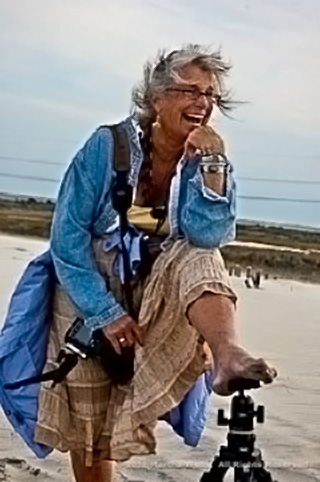 Beach photo of Margo Taussig Pinkerton with her foot on top of a tripod by Martha Wells.