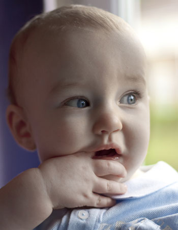 Close-up photo portrait of a baby using window light and a reflector by Cathy Topping.
