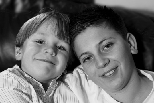 Close-up black and white photo portrait of two brothers by Cathy Topping.