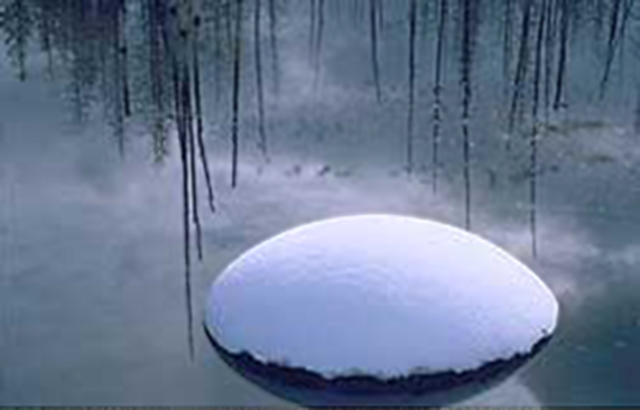Image of a rock with snow on top in a winter pond in Wyoming by Brenda Tharp.