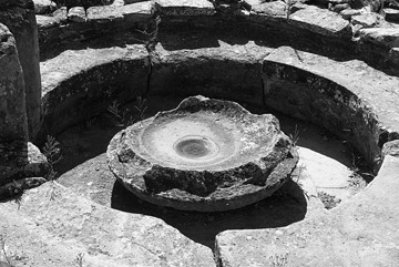 Photo of circular bench enclosing a circular basin meant for religious rites, nuraghe Su Nuraxi, Barumini, Cagliari by John Tollefsen