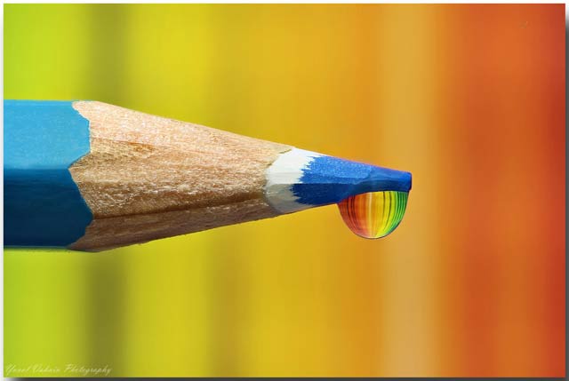 Glycerin Drop Reflection Photos with Focus Stacking: Reflection of colors in drop on end of blue colored pencil by Yuval Vaknin.