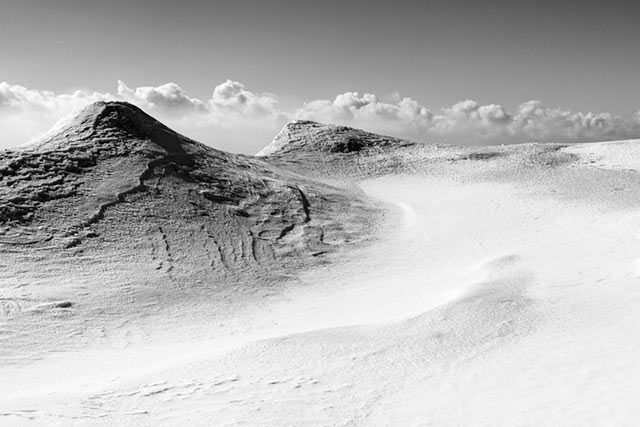 Black and white image of Canadian mountain peaks in the snow by Randall Romano.