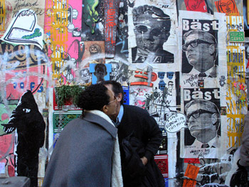 Photo of New York people on street and wall covered with graffiti art by Ned Harris.
