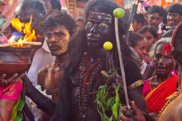 Dasara festival in India: person dressed as Goddess Kali, the black Goddes of death, in the crowded street by Kris Hariharan.