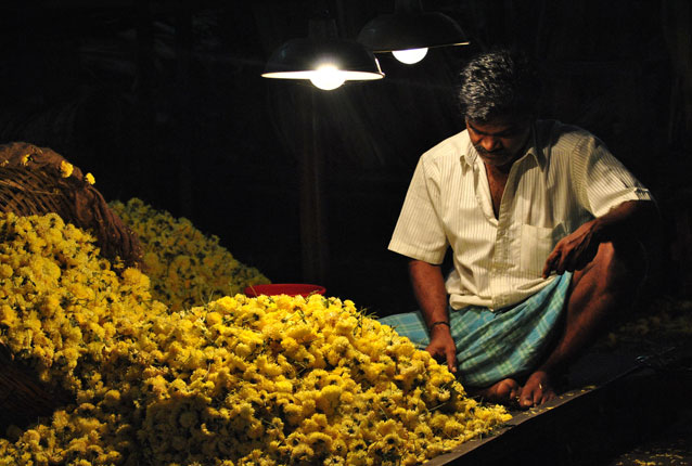 Photo of man selling flowers in India by Shilpa Reddy Perugu