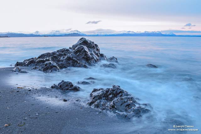 Long exposure captures the rocks and blue crashing waves at Isthmus Bay on Kodiak Island, Alaska by Joseph Classen.