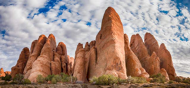 Landscape image of rock formations and beautiful cloudy sky at Arches National Park, Utah by Michael Leggero.