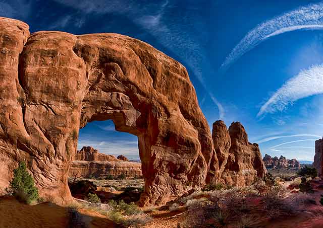 Landscape image of rock formations seen through a rock arche at Arches National Park, Utah by Michael Leggero.