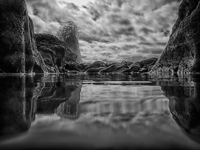Black and white reflection of rocky cliffs at Olympic National Park, Washington by Michael Leggero.