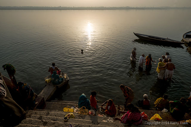 People near and in the river at Varanasi, India for prayers and a sacred bath by Harry Fisch.