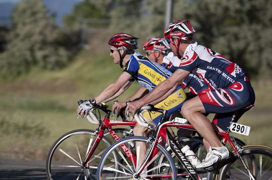 Photo of 3 bicycle racers moving on their bikes by Brad Sharp.