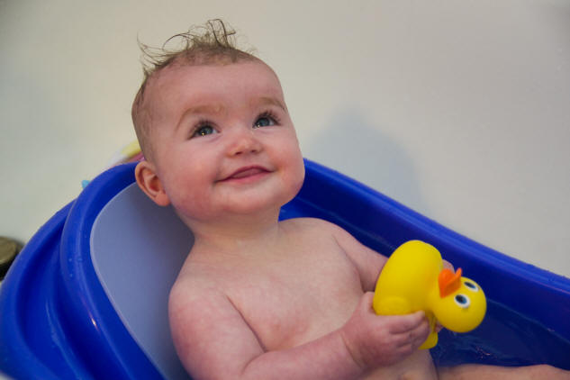 Photo of Baby A enjoying her bath and yellow rubber duck by Elizabeth Powis Fulks.