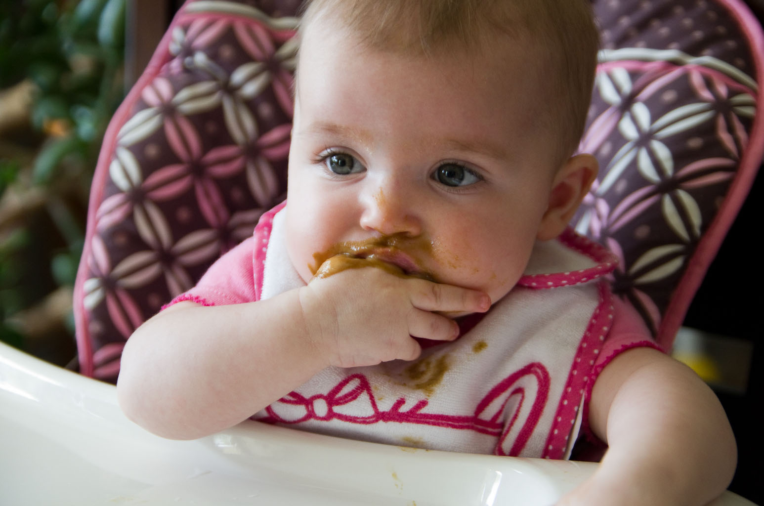 Photo of Baby A tasting solid food for the first time by Elizabeth Powis Fulks.